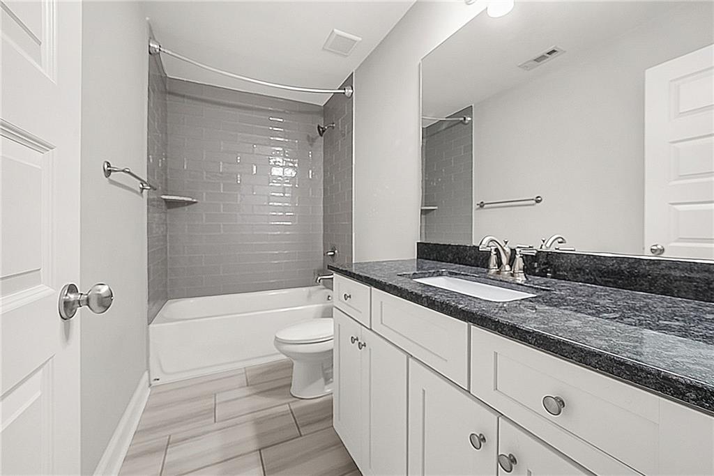 2519 Hog Liver Road Carrollton, GA 30117 - Photo 20 of 39 a bathroom with a granite countertop sink toilet and shower