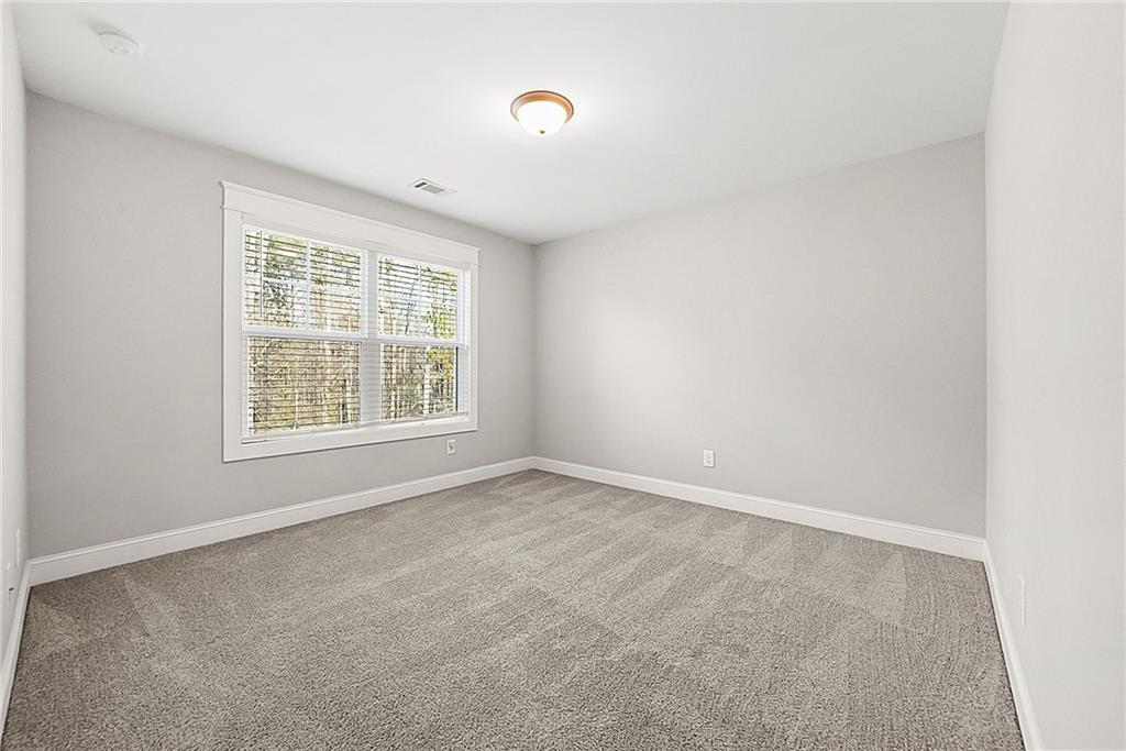 2519 Hog Liver Road Carrollton, GA 30117 - Photo 21 of 39 an empty room with windows