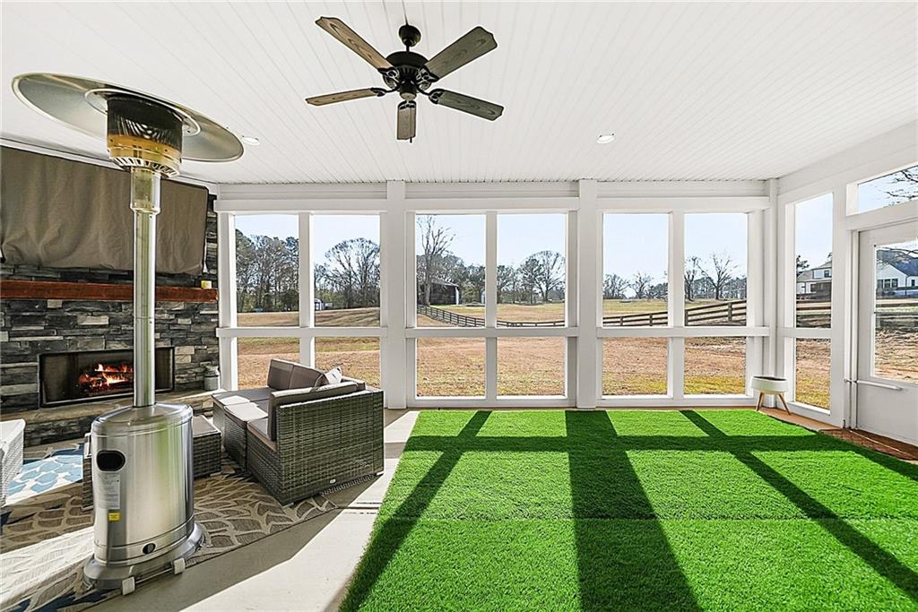 2519 Hog Liver Road Carrollton, GA 30117 - Photo 29 of 39 a living room with a floor to ceiling window and a flat screen tv