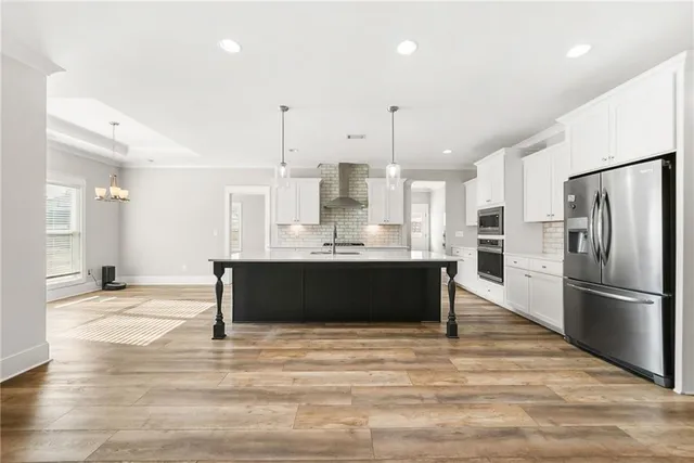 a large kitchen with kitchen island a sink stainless steel appliances and cabinets
