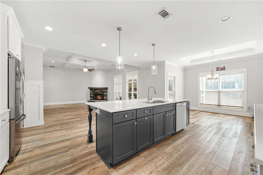 2519 Hog Liver Road Carrollton, GA 30117 - Photo 7 of 39 a large kitchen with kitchen island a sink stainless steel appliances and cabinets