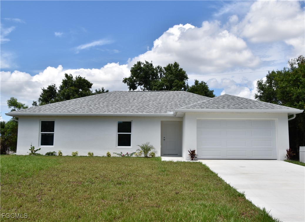 a front view of house with yard and trees