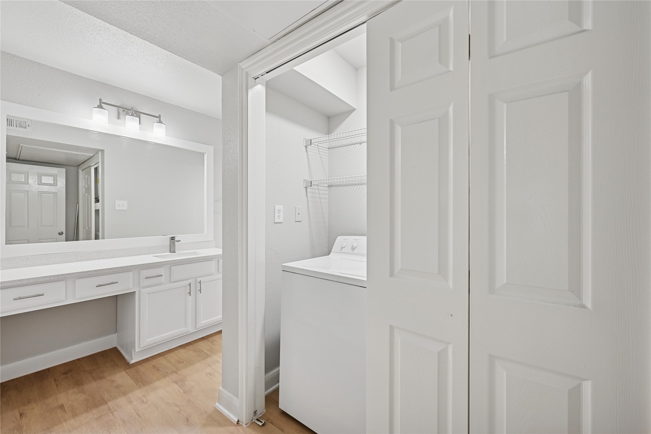 10990 West Road, Unit 203 Houston, TX 77064 - Photo 23 of 23 a bathroom with a granite countertop sink and a mirror