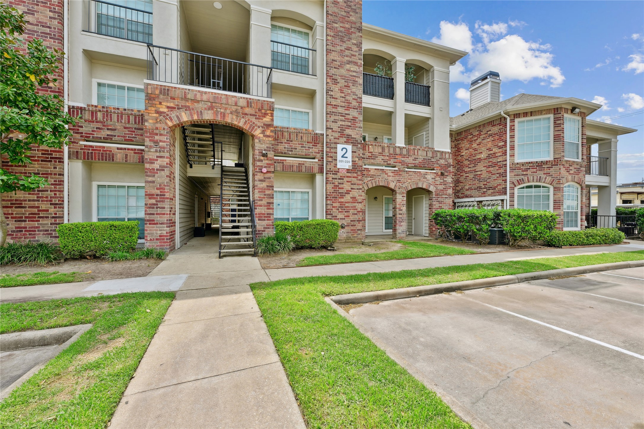 10990 West Road, Unit 203 Houston, TX 77064 - Photo 5 of 23 a front view of a building with a yard