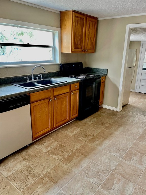 86114 Harry Green Road Yulee, FL 32097 - Photo 12 of 24 a kitchen with granite countertop a stove a sink and a microwave