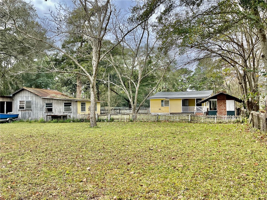 86114 Harry Green Road Yulee, FL 32097 - Photo 18 of 24 a front view of a house with a garden