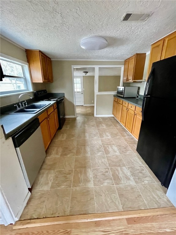 86114 Harry Green Road Yulee, FL 32097 - Photo 3 of 24 a kitchen with granite countertop a stove and a refrigerator