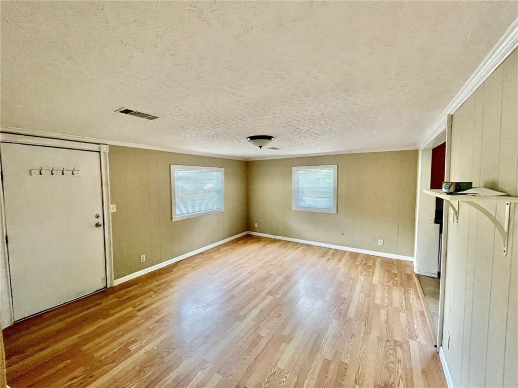 86114 Harry Green Road Yulee, FL 32097 - Photo 4 of 24 a view of empty room with wooden floor and fan