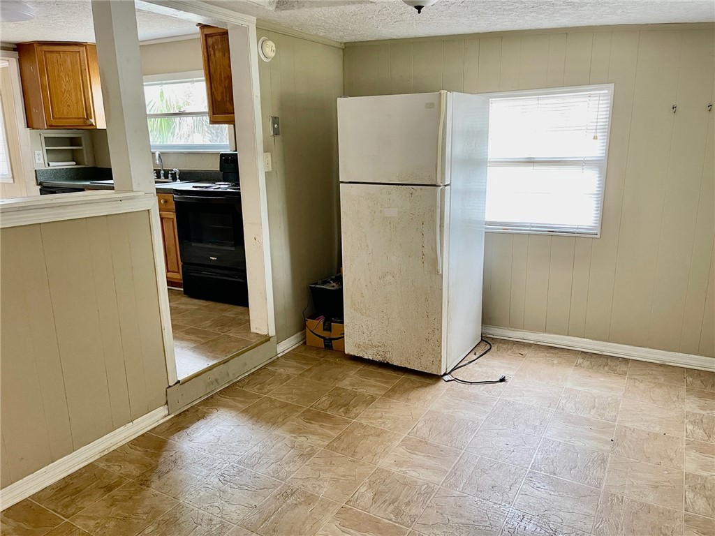 86114 Harry Green Road Yulee, FL 32097 - Photo 10 of 24 a view of a kitchen with a refrigerator a stove top oven a refrigerator and a window