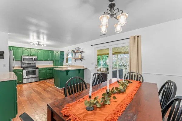 a dining room with furniture a rug and wooden floor