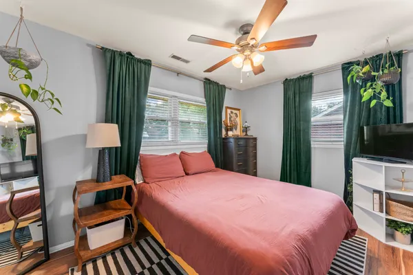 a bedroom with a bed and a chandelier