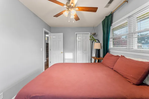 a bedroom with a bed and a chandelier