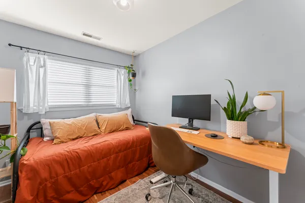 a bedroom with a bed and a window