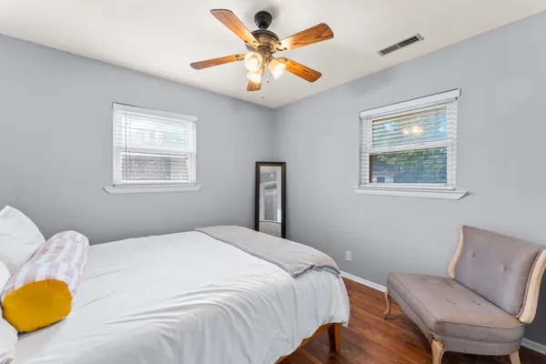 a bedroom with a bed and chair