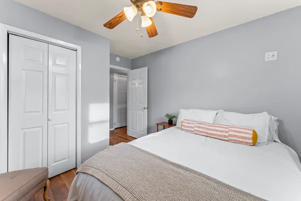 a bedroom with a bed and a chandelier