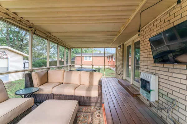 a balcony with furniture and a fireplace