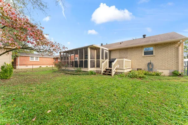 a backyard of a house with table and chairs