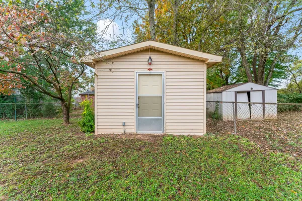 a view of a house with a yard and garage