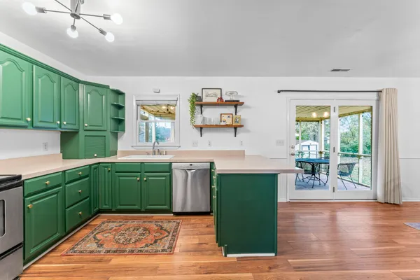 a kitchen with cabinets and wooden floor
