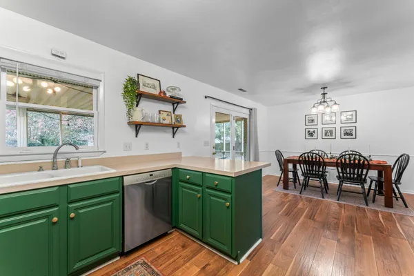 a kitchen with a sink cabinets and dining table