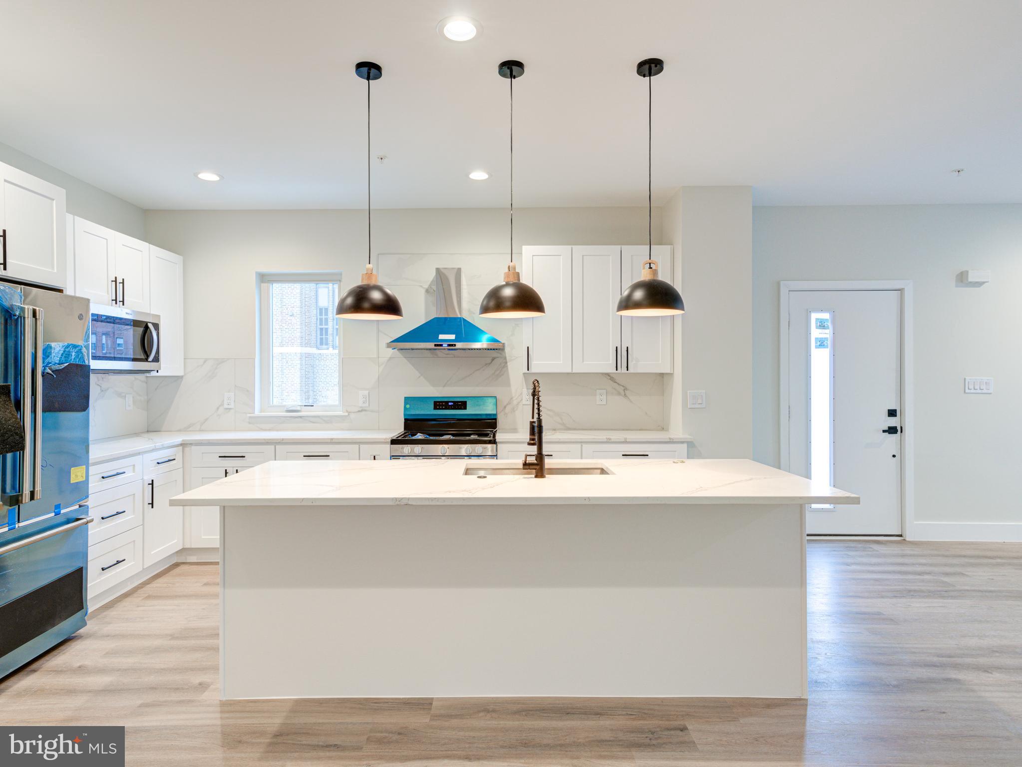 630 Moyer Street Philadelphia, PA 19125 - Photo 29 of 41 a kitchen with stainless steel appliances granite countertop a sink a stove and a wooden floors