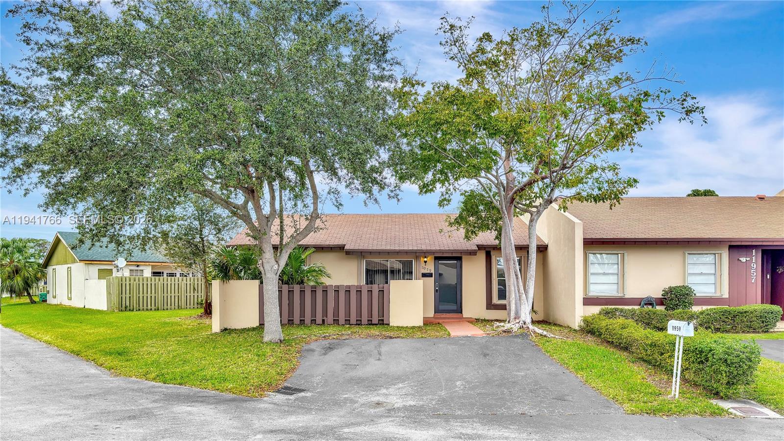 11959 Southwest 110th St Circle South Miami, FL 33186 - Photo 2 of 13 front view of a house with a yard