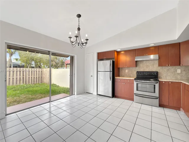 a kitchen with stainless steel appliances a refrigerator and a stove top oven