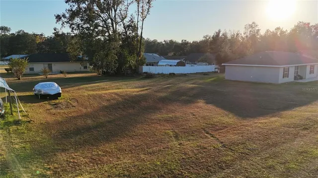 a view of a field with an ocean