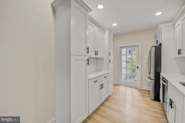 a bathroom with granite countertop a sink a toilet and shower