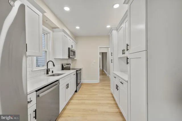 a large kitchen with stainless steel appliances lots of counter top space