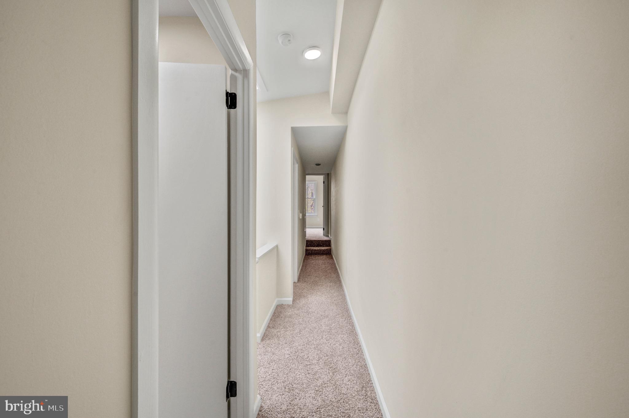 207 Jackson Street Trenton, NJ 08611 - Photo 16 of 37 a view of a hallway with a white walls