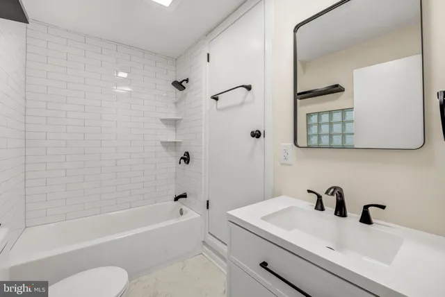 a bathroom with a sink a toilet and a bathtub