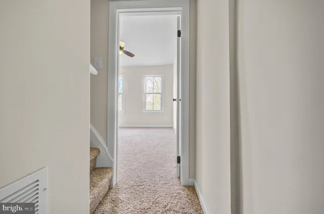 a view of a bathroom from a hallway