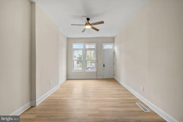 wooden floor in an empty room with a window