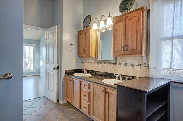 a bathroom with a sink toilet vanity and shower
