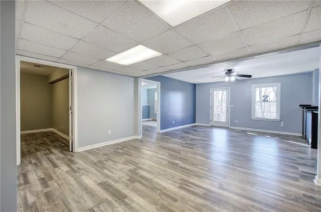 a view of an empty room with wooden floor