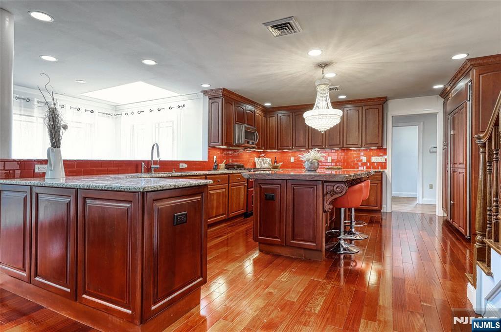 91 Chestnut Ridge Road Saddle River, NJ 07458 - Photo 14 of 50 a kitchen with a sink stove and cabinets