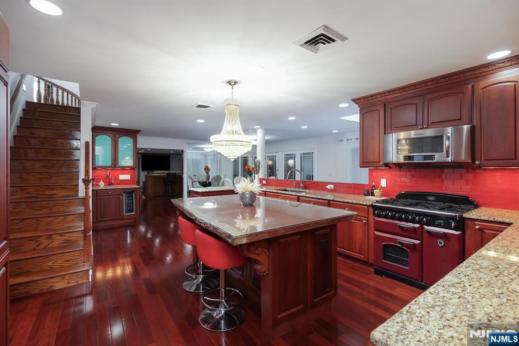 91 Chestnut Ridge Road Saddle River, NJ 07458 - Photo 15 of 50 a kitchen with stainless steel appliances granite countertop a sink stove and a wooden floors