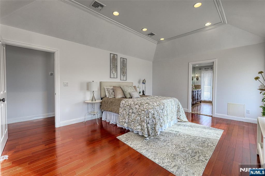 91 Chestnut Ridge Road Saddle River, NJ 07458 - Photo 19 of 50 a bedroom with a bed and wooden floor