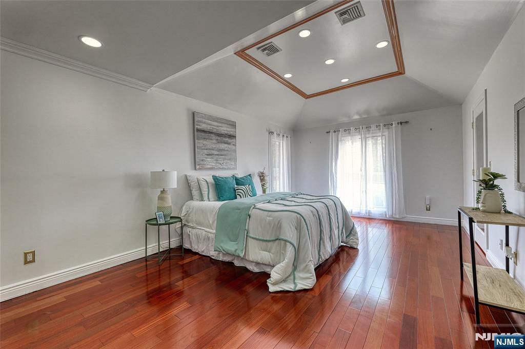 91 Chestnut Ridge Road Saddle River, NJ 07458 - Photo 20 of 50 a bedroom with a bed and wooden floor