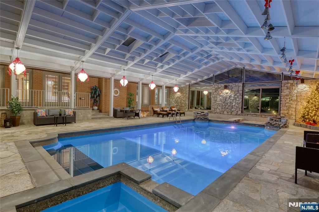 91 Chestnut Ridge Road Saddle River, NJ 07458 - Photo 2 of 50 a view of a swimming pool with a patio