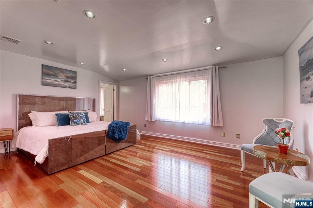91 Chestnut Ridge Road Saddle River, NJ 07458 - Photo 21 of 50 a bedroom with a bed and wooden floor