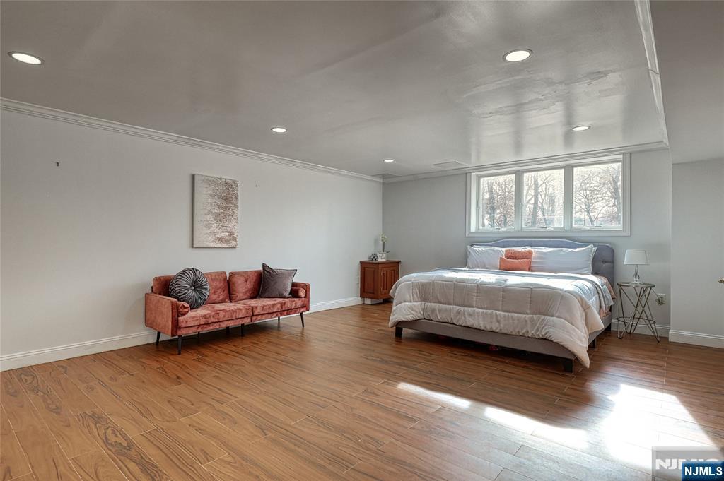 91 Chestnut Ridge Road Saddle River, NJ 07458 - Photo 23 of 50 a spacious bedroom with a bed and a couch