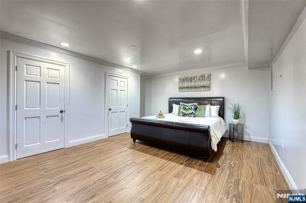 91 Chestnut Ridge Road Saddle River, NJ 07458 - Photo 24 of 50 a spacious bedroom with a bed and wooden floor
