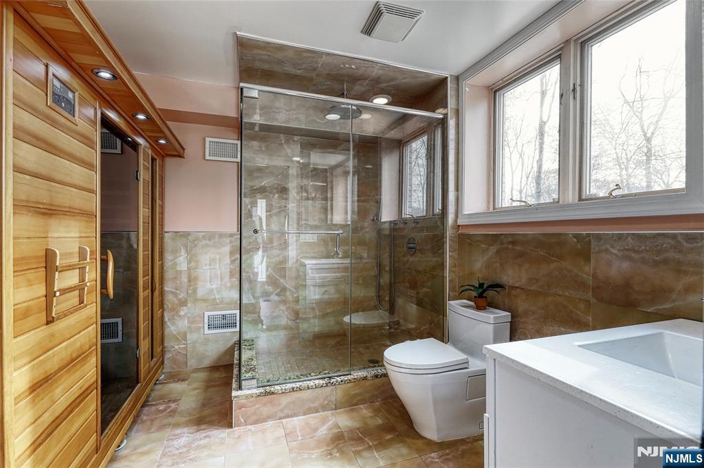 91 Chestnut Ridge Road Saddle River, NJ 07458 - Photo 28 of 50 a bathroom with a toilet a sink and a shower