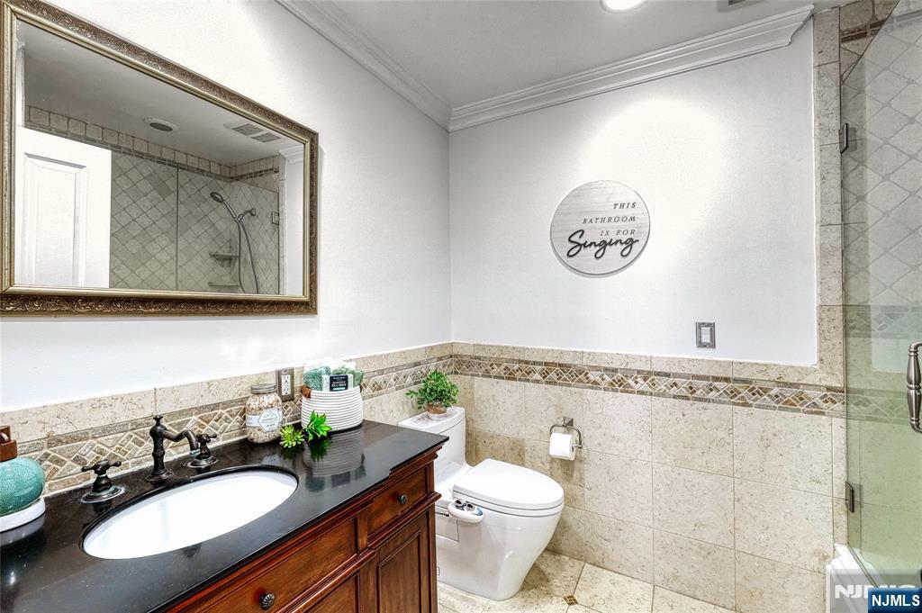 91 Chestnut Ridge Road Saddle River, NJ 07458 - Photo 29 of 50 a bathroom with a granite countertop sink mirror vanity and toilet