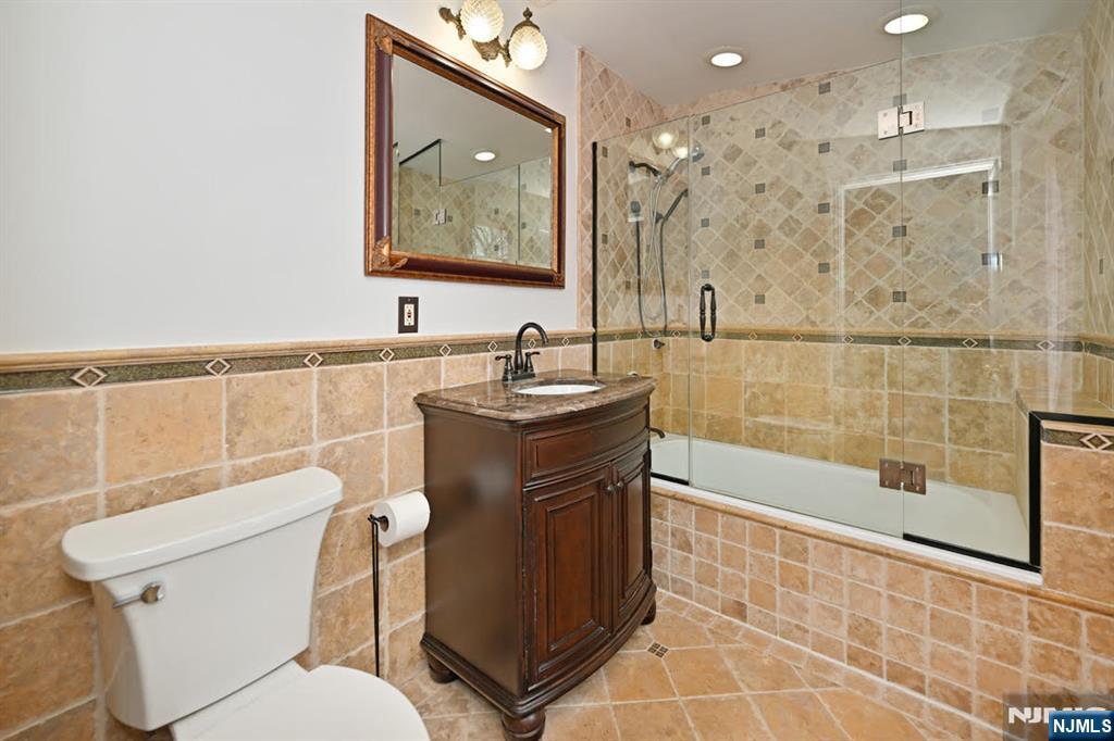 91 Chestnut Ridge Road Saddle River, NJ 07458 - Photo 31 of 50 a bathroom with a sink toilet and shower