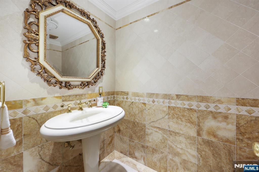 91 Chestnut Ridge Road Saddle River, NJ 07458 - Photo 32 of 50 a bathroom with a sink and a mirror