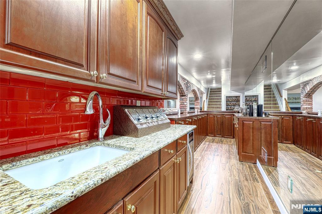 91 Chestnut Ridge Road Saddle River, NJ 07458 - Photo 35 of 50 a kitchen with stainless steel appliances kitchen island granite countertop a sink and cabinets