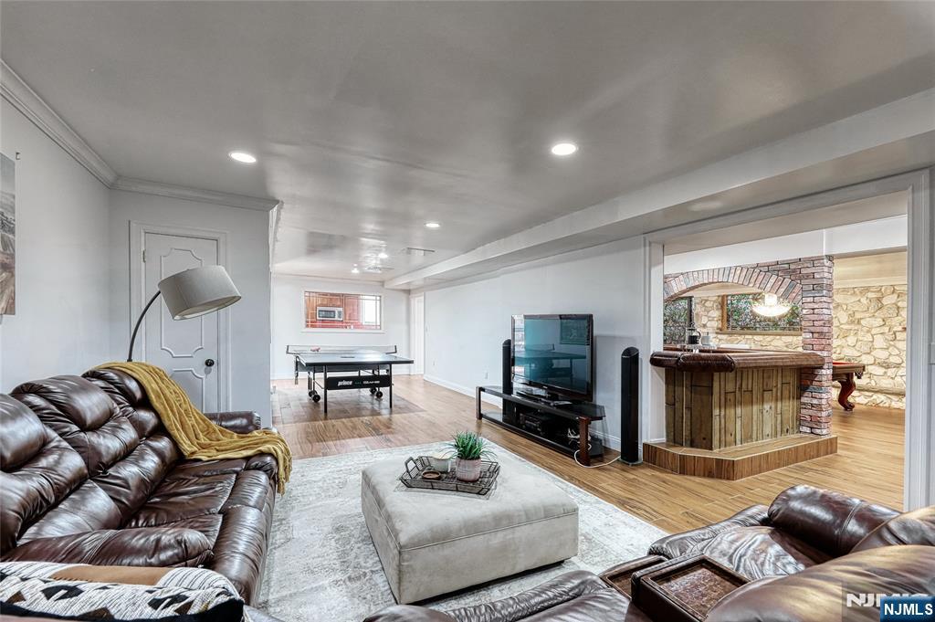 91 Chestnut Ridge Road Saddle River, NJ 07458 - Photo 38 of 50 a living room with furniture and a flat screen tv
